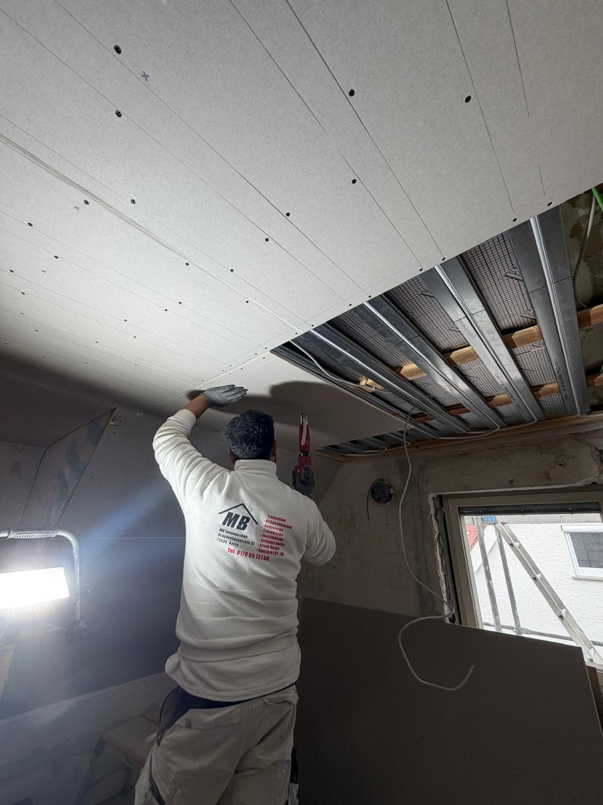 MB-Mitarbeiter bei der Deckenmontage auf der Baustelle